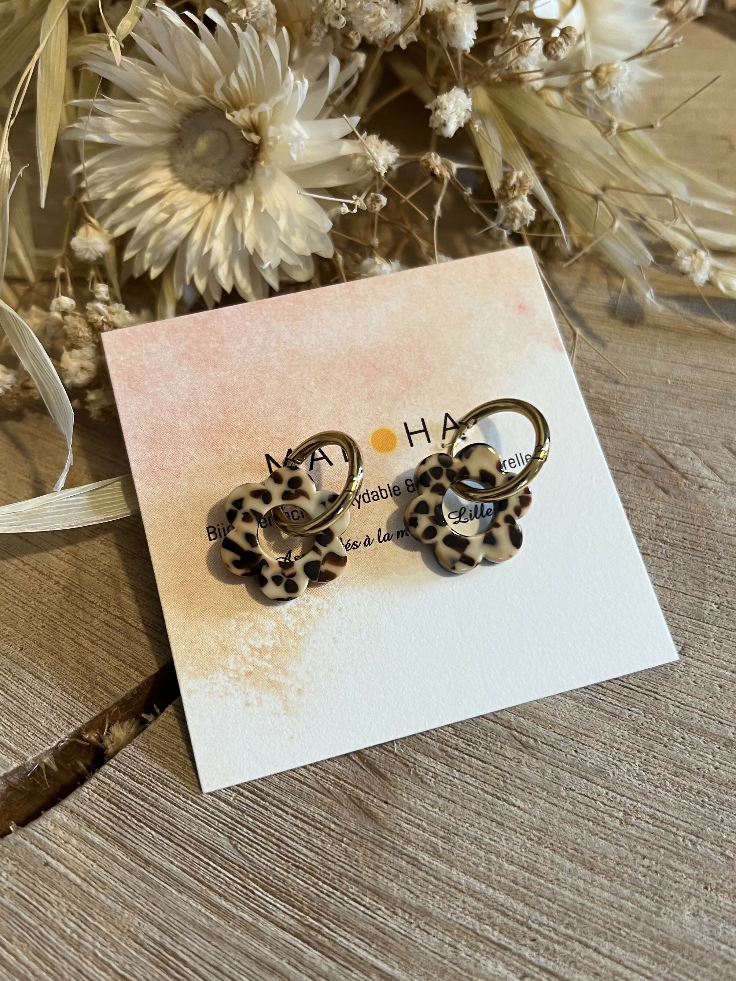 Gold hoop earrings & their beige-brown flowers